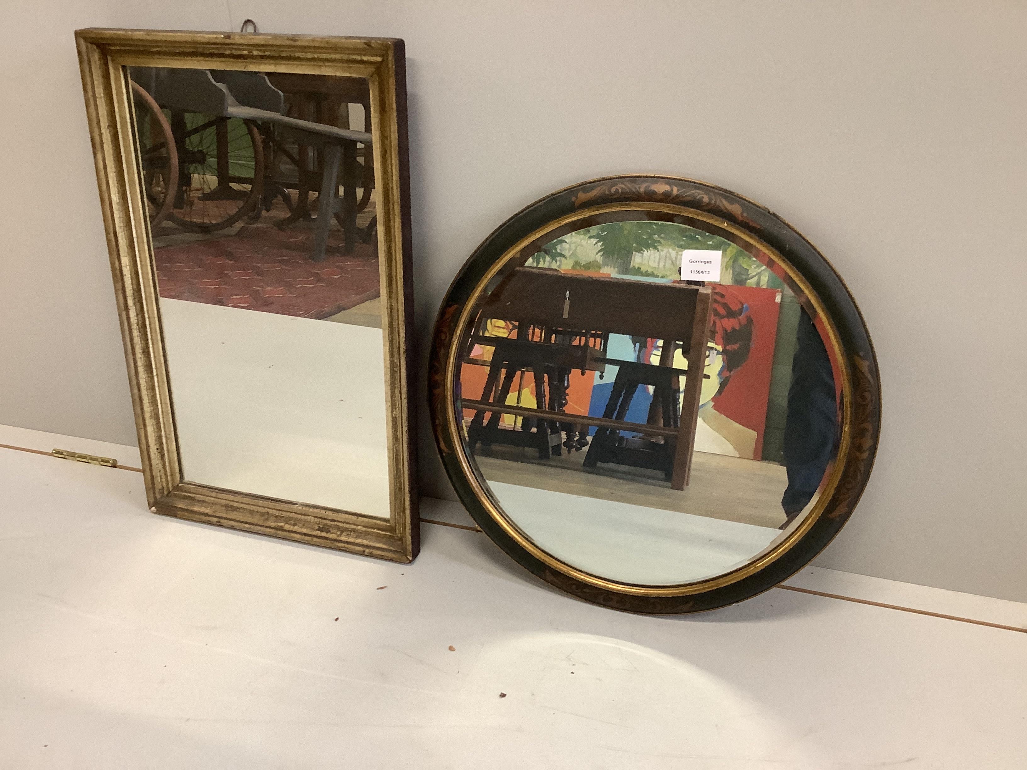 A circular lacquered bevelled wall mirror, diameter 50cm, together with a rectangular gilt framed wall miror